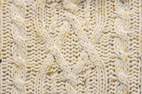 The texture of a knitted beige sweater. — Stock Photo, Image