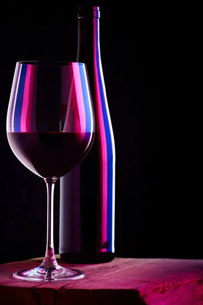 Glass of red wine with bottle — Stock Photo, Image