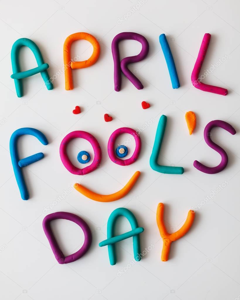 April Fools Day phrase made of plasticine colorful letters on background