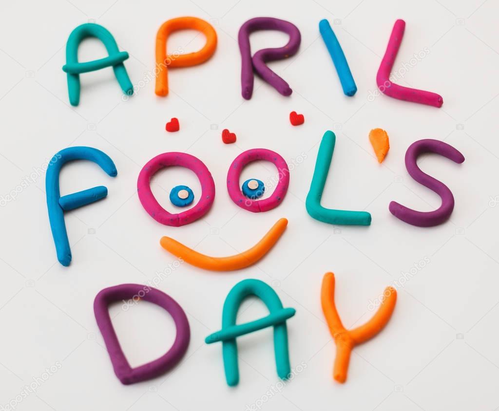 April Fools Day phrase made of plasticine colorful letters on background