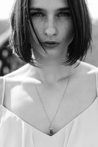 Brunette girl in a dress with a neckline — Stock Photo, Image