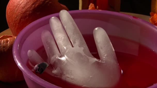 Ice frozen hand with a scary ring with skull in Halloween punch — Stock Video