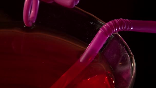 Super closeup shot of red cocktail on black background — Stock Video