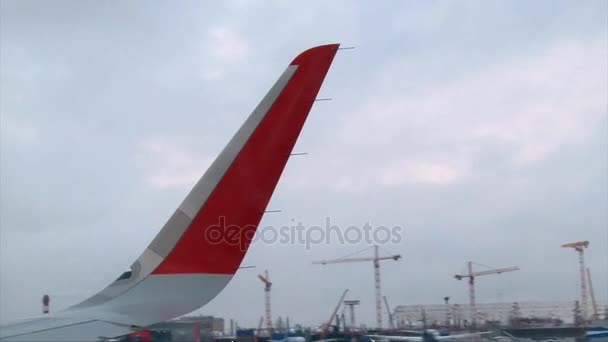 Airplane taking off from airport near other planes, winter snow day — Stock Video