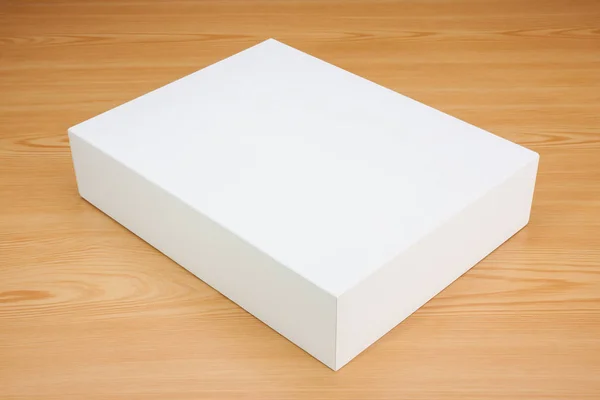 Boş beyaz kutu ahşap arka plan üzerinde sahte kadar — Stok fotoğraf
