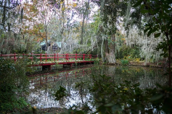 Bright, red bridge in the garden in Charleston, South Carolina. Spanish moss