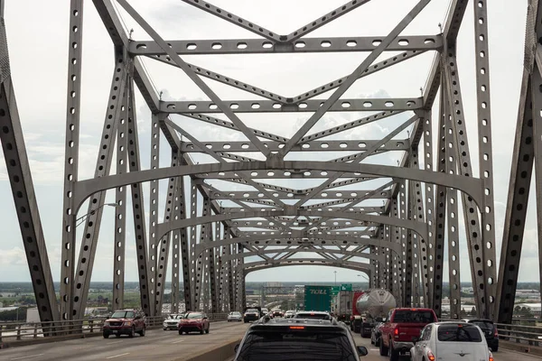 Cars go on big bridge on summer day. Mississippi River, MS, USA, 13 July 2018