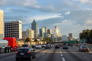 Atlanta, Georgia / USA   - September 11, 2018. Many cars on the highway among giant buildings in a big city on a sunny day