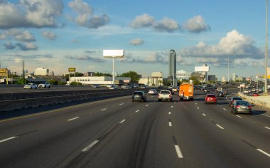 Houston, Texas, USA, September 15, 2018. Many cars on the highway among giant buildings, big bridges in a big city on a sunny day with beautiful blue sky 