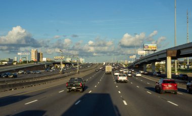 Houston, Texas, USA, September 15, 2018. Many cars on the highway among giant buildings, big bridges in a big city on a sunny day with beautiful blue sky 