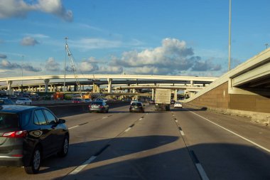 Houston, Texas, USA, September 15, 2018. Many cars on the highway among giant buildings, big bridges in a big city on a sunny day with beautiful blue sky 