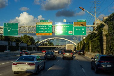 Houston, Texas, USA, September 15, 2018. Many cars on the highway among giant buildings, big bridges in a big city on a sunny day with beautiful blue sky 