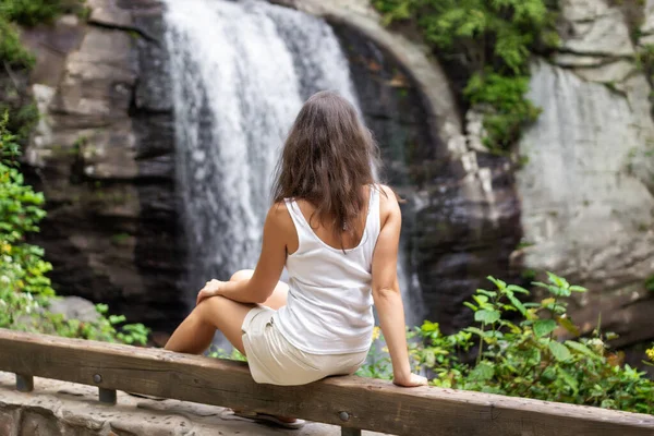 Jeune Fille Est Assise Près Une Grosse Cascade Repose Les Photos De Stock Libres De Droits