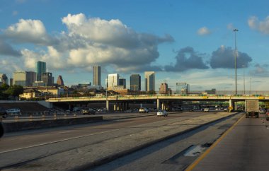 Houston, Texas, USA, September 15, 2018. Many cars on the highway among giant buildings, big bridges in a big city on a sunny day with beautiful blue sky 
