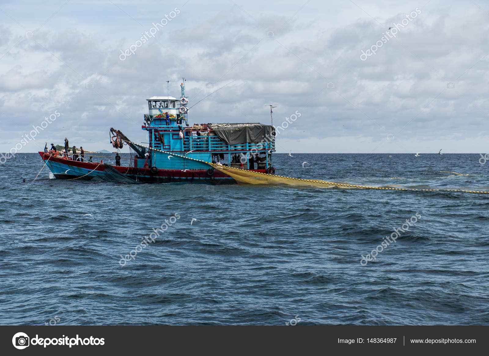 Fishing boat big fishermen with fish net on the blue ocean thailand catch  fish Stock Photo by ©donogl 148364987