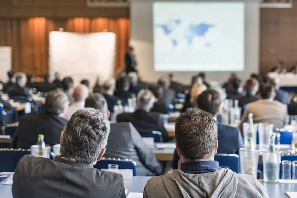 Rear view aged businessman receiving report with partners at conference hall meeting business — Stock Photo, Image