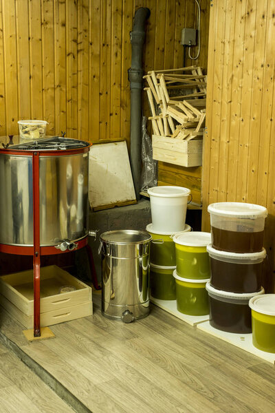 buckets full of extracted honey out of centrifuge and other Beekeeper equipment