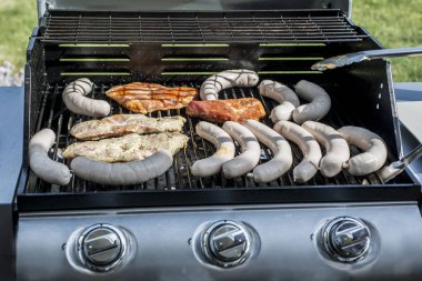 Barbecue grill bbq on propane gas grill steaks bratwurst sausages meat meal clipart