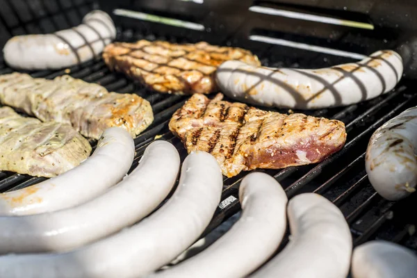 Barbecue grill bbq on propane gas grill steaks bratwurst sausages meat meal — Stock Photo, Image