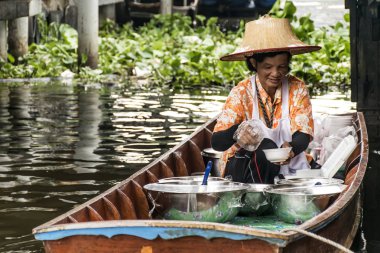Bangkok Thailand 03.10.2015 Taling chan traditional floating market local people selling fresh goods clipart
