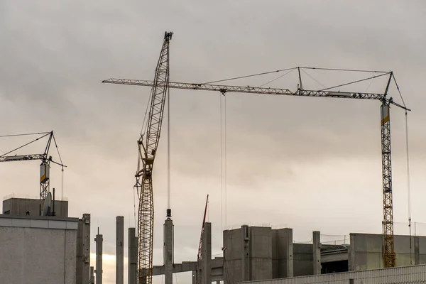 Concrete construction yard building site crane cloudy sky background — Stock Photo, Image