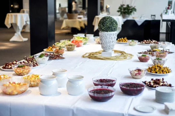 Variety of fresh salads bowls on buffet table business dinner — Stock Photo, Image