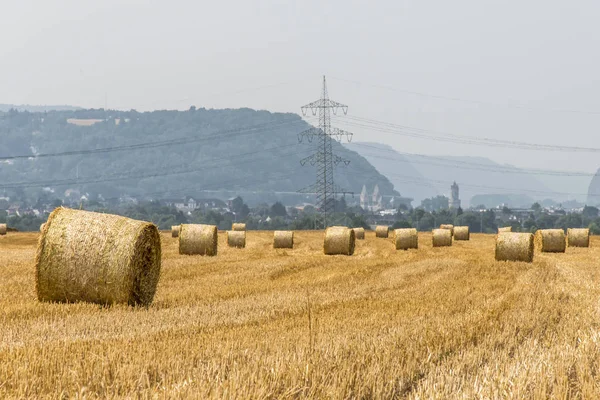 Harvested field agriculture with straw bales during summer germany near Andernach — Stock Photo, Image