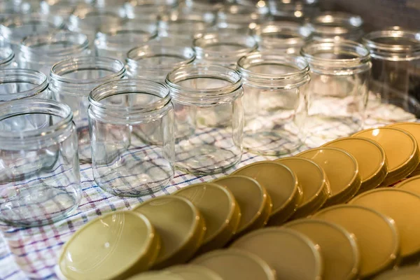 many glass jar empty glasses row for jam honey with lid caps abstract background bokeh