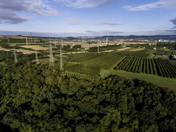 Aerial view High voltage metal post. High-voltage tower Top view green landscape tree plaantage fruit produce — Stock Photo, Image