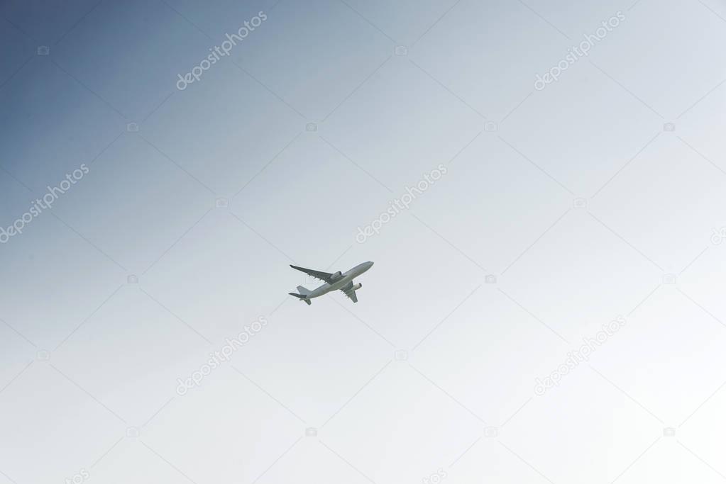 White airplane profile plane climb up the height of cloud sun glare blank no label