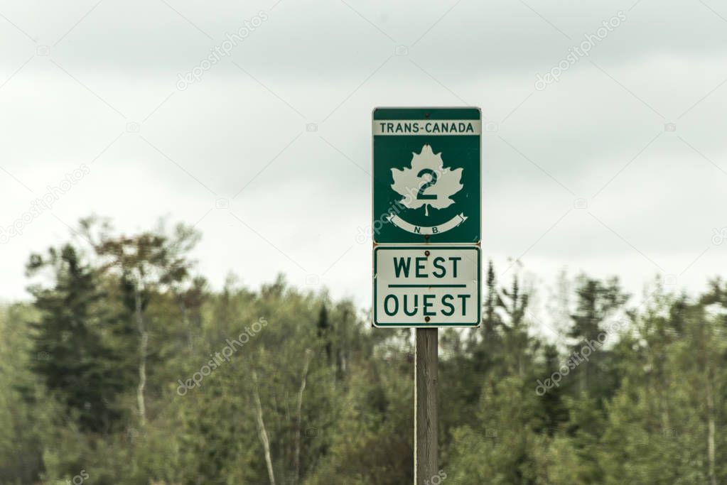 Signpost with green sign of Trans Canada 2 Highway west direction connecting the east- and west coast