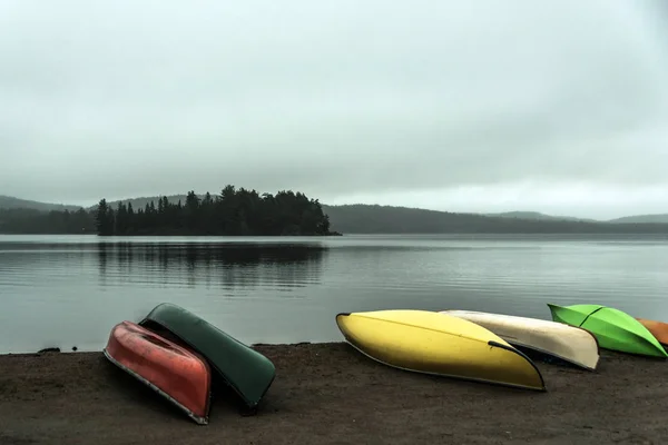 Canada Ontario Lake two rivers grey morning dark atmosphere Canoe Canoes parked beach water in Algonquin National Park — Stock Photo, Image