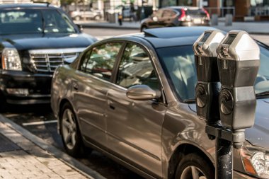 Boston MA USA 04.09.2017 Boston USA Massachusetts Parking meter at paid parking in the street with cars behind it clipart