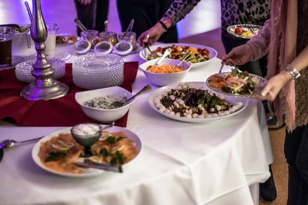 People group catering buffet at food table luxury restaurant with meat, bread and different salad — Stock Photo, Image