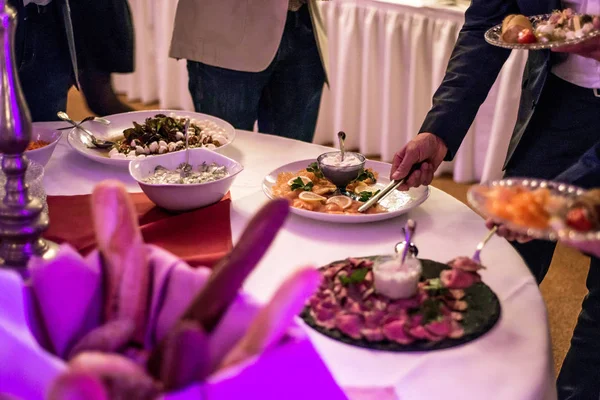 People group catering buffet at food table luxury restaurant with meat, bread and different salad — Stock Photo, Image