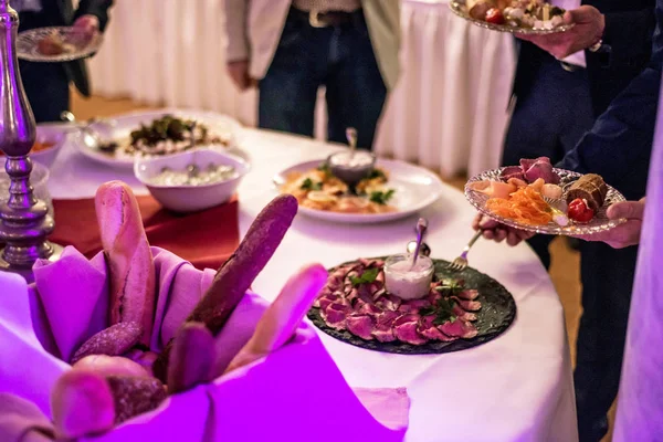 People group catering buffet at food table luxury restaurant with meat, bread and different salad — Stock Photo, Image