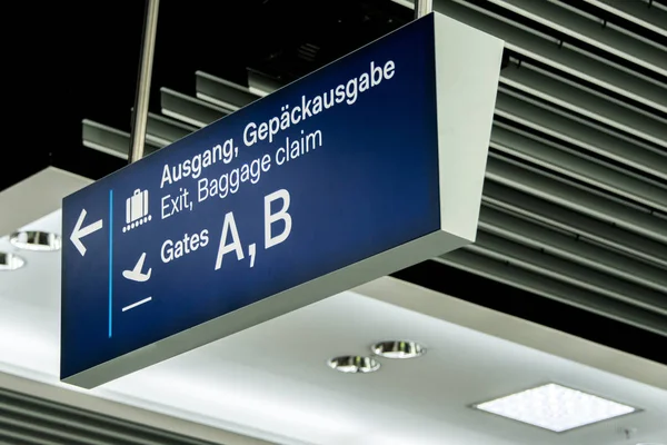 german airport dusseldorf exit and baggage claim blue sign gates A and B