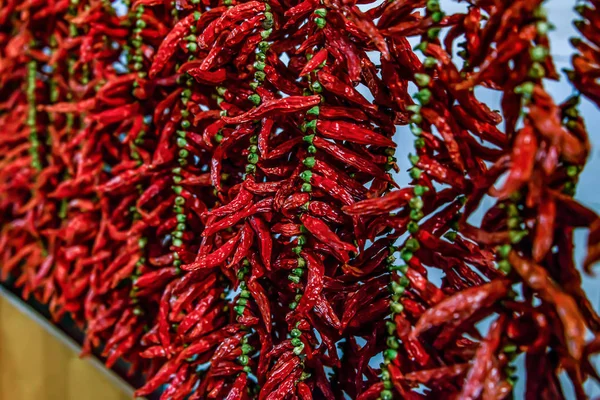 Close up view of hanging hot dried chili peppers on the local farmers market Mercado dos Lavradores in Funchal Madeira — Stock Photo, Image