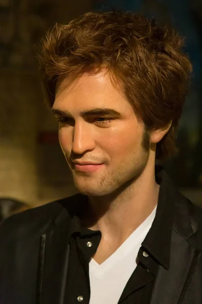NEW YORK CITY, USA  JULE 13, 2013: A visitor to the museum next to the wax figure of Robert Pattinson in Madame Tussauds wax museum in Times Square in New York.