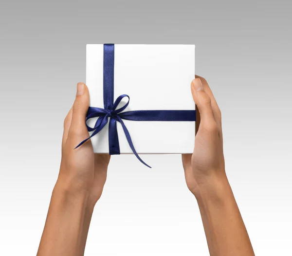 Isolated Woman Hands holding Holiday Present White Box with Blue Ribbon on a White Background — Stock Photo, Image