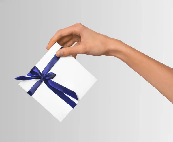 Woman Hand holding Holiday Present White Box with Blue Ribbon — Stock Photo, Image