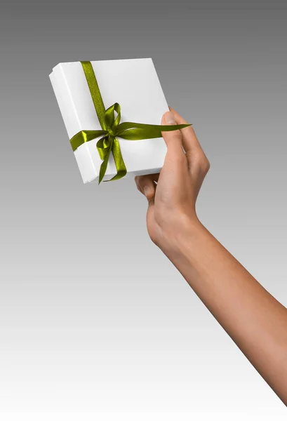 Woman Hand holding Holiday Present White Box with Green Ribbon — Stock Photo, Image