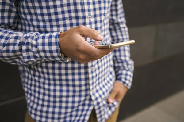 Man in casual wear or hipster relax and holding mobile smart phone, close up, daily morning news update concept.