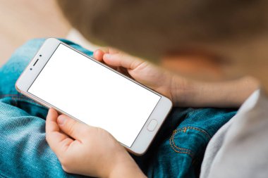 Küçük çocuk kullanım cep telefonu beyaz kadar sahte için ekran. Beyaz, boş, ekran mockup izole