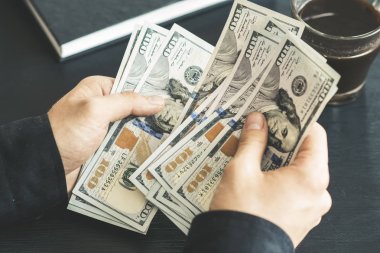 tekrar sayım dolar ver. adam parayı sayar. yeni yüz dolarlık banknot. Yeni Finans teknolojileri ve iş haberleri kavramları. Yatay