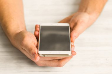 El kredi kartı tutan ve smartphone kullanarak smartphone ekran akıllı telefon ellerini yakın kullanan adam. Online ödeme plastik kart.