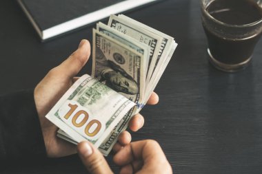 tekrar sayım dolar ver. adam parayı sayar. yeni yüz dolarlık banknot. Yeni Finans teknolojileri ve iş haberleri kavramları. Yatay