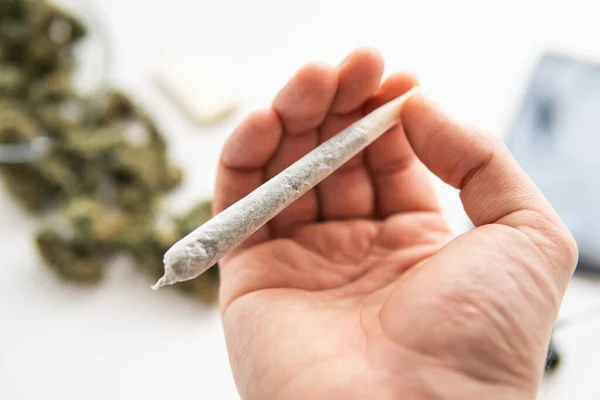 Porro Con Marihuana Mano Cerca Brotes Cannabis Sobre Fondo Mesa —  Fotos de Stock
