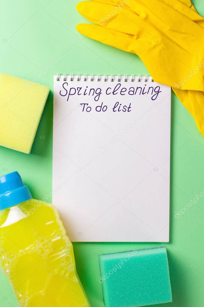 Cleaning set for spring regular clean up on green background. Blanck for to do list. Copy space. 