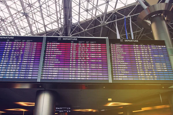 Flights information board in airport terminal — Stock Photo, Image